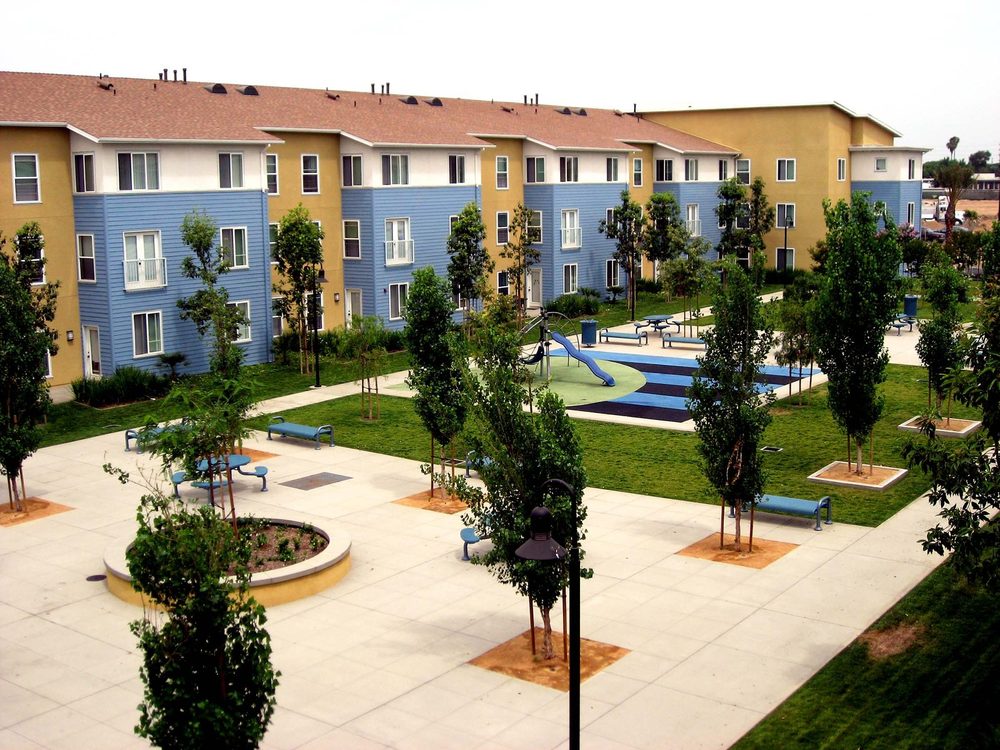 Courtyard, playground and three-story buildings at Harbor View Place