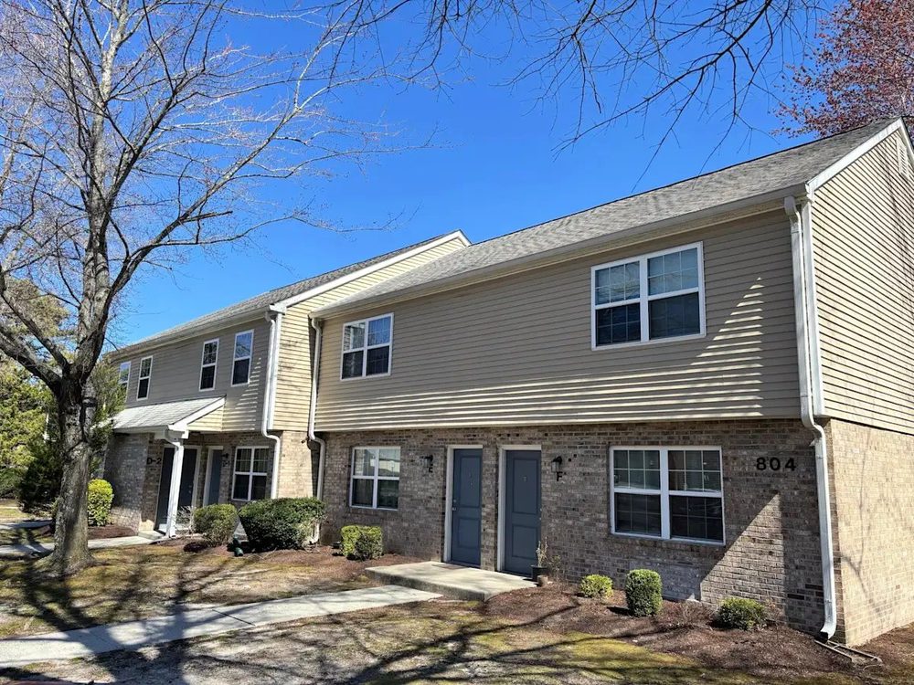 Two-story brick and siding townhomes at James Leonard Apartments