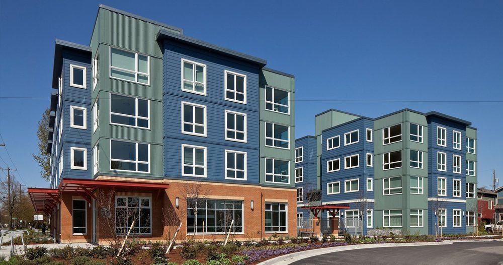 Rose Street Apartments, blue and green buildings above a planted street corner